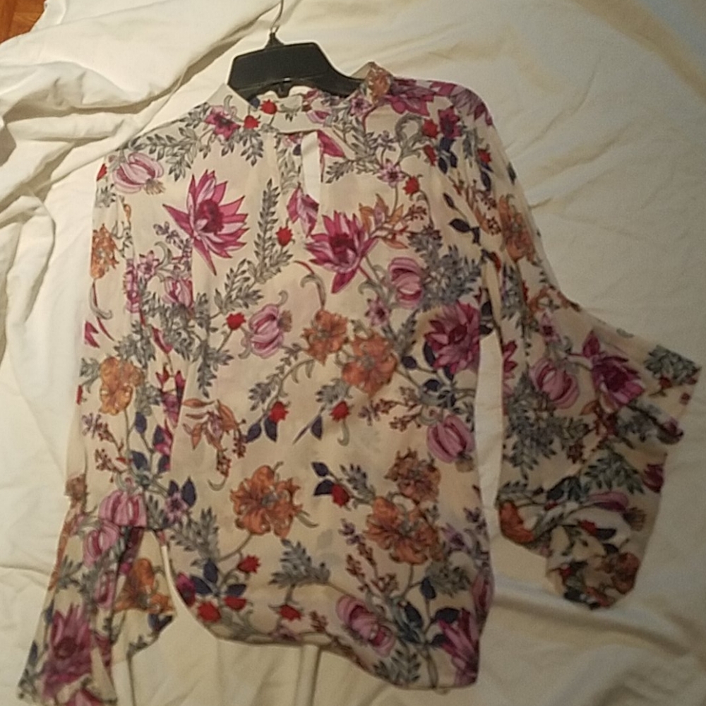 Blouse with waterfall ruffle wrists.